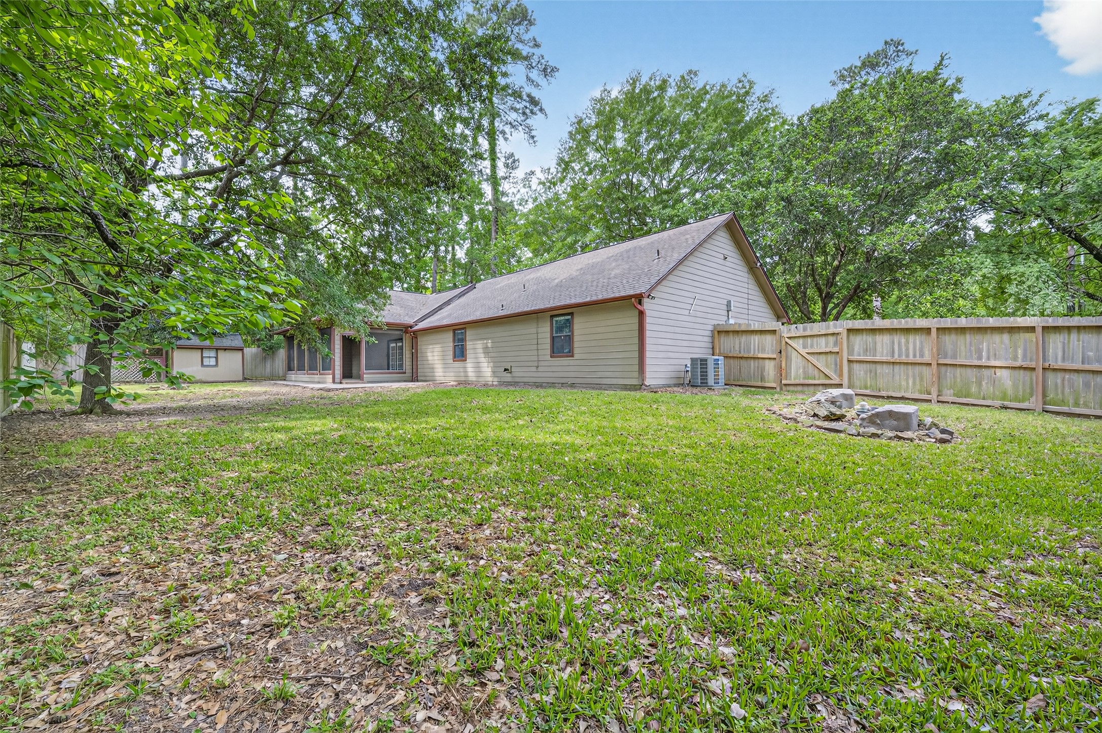 1007 West Cedar River Road Conroe, TX 77316 - Photo 43 of 48 a view of a house with backyard and a tree