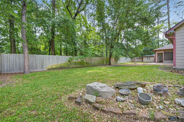 a view of a yard with furniture and garden