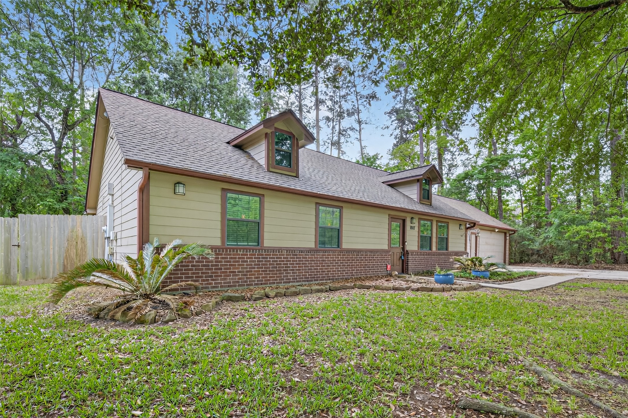 1007 West Cedar River Road Conroe, TX 77316 - Photo 46 of 48 a front view of a house with a yard and outdoor seating
