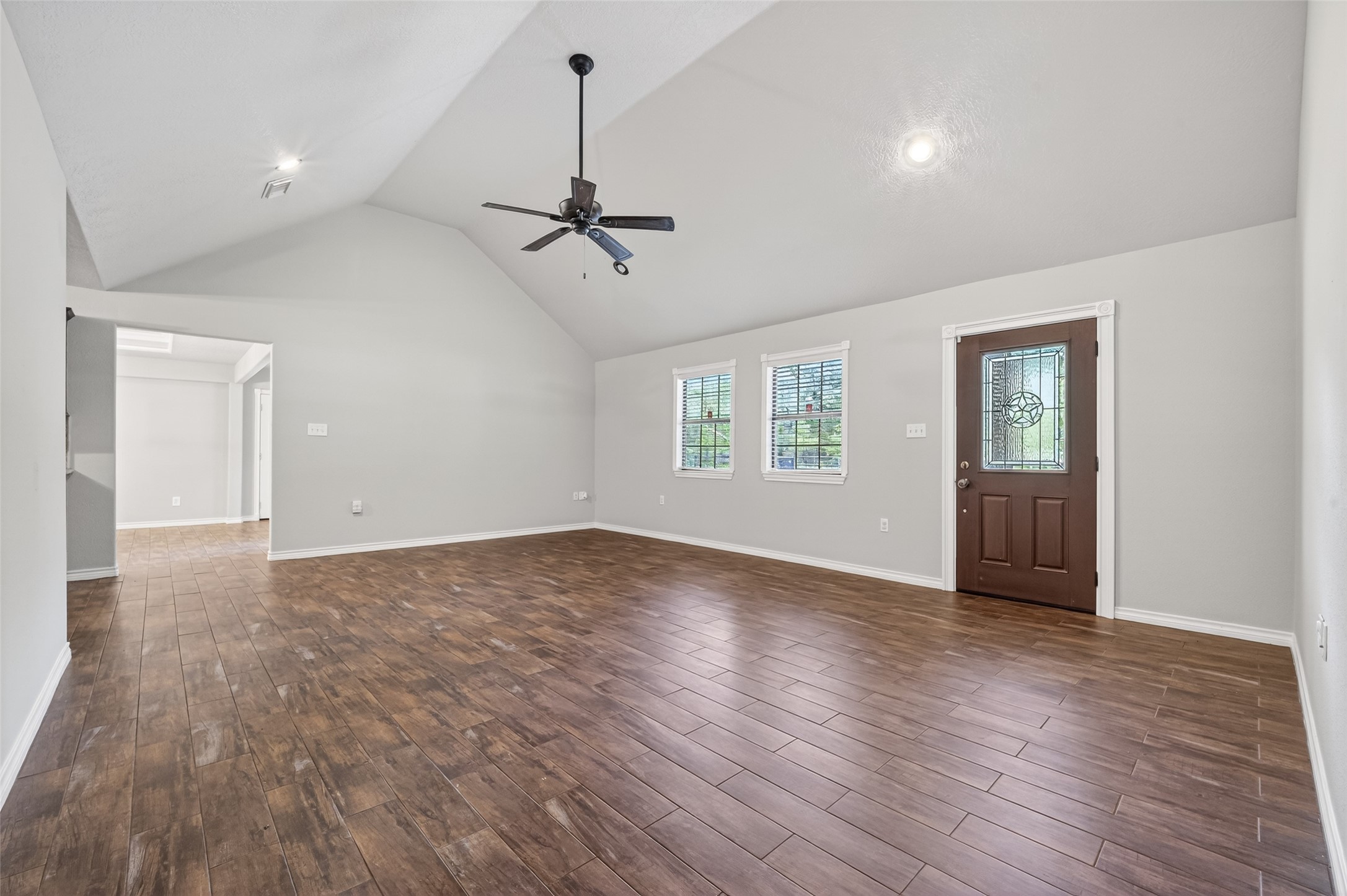 1007 West Cedar River Road Conroe, TX 77316 - Photo 5 of 48 a view of empty room with wooden floor and ceiling fan