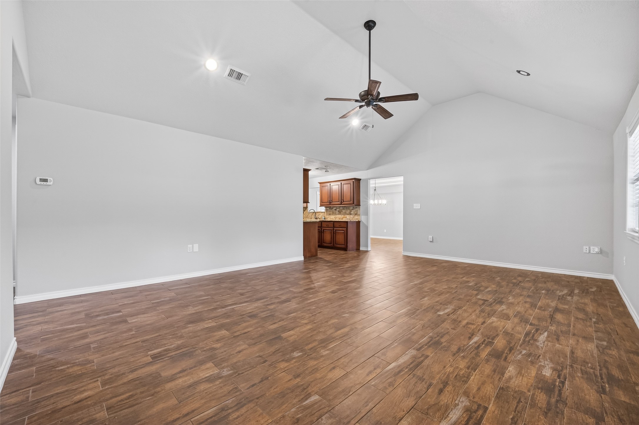 1007 West Cedar River Road Conroe, TX 77316 - Photo 6 of 48 a view of empty room with wooden floor and ceiling fan
