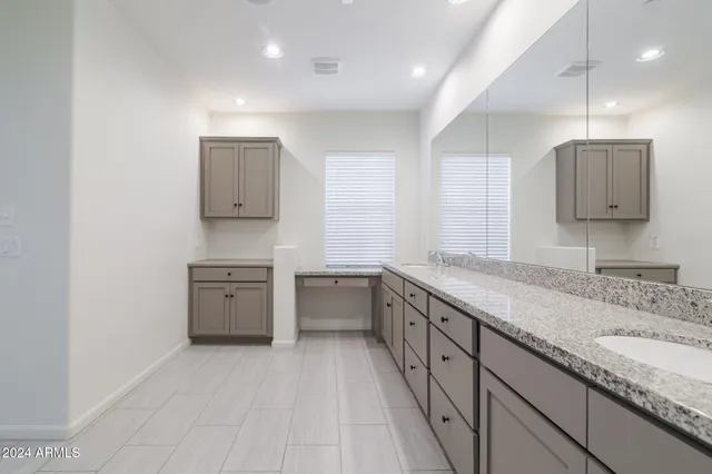 a kitchen with granite countertop a sink and a stove top oven