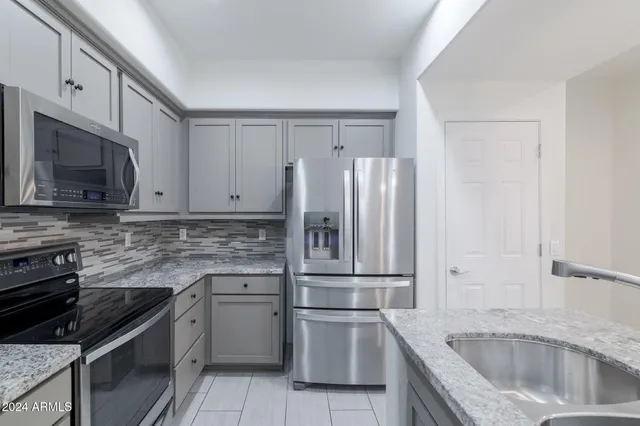a kitchen with a sink stove and refrigerator