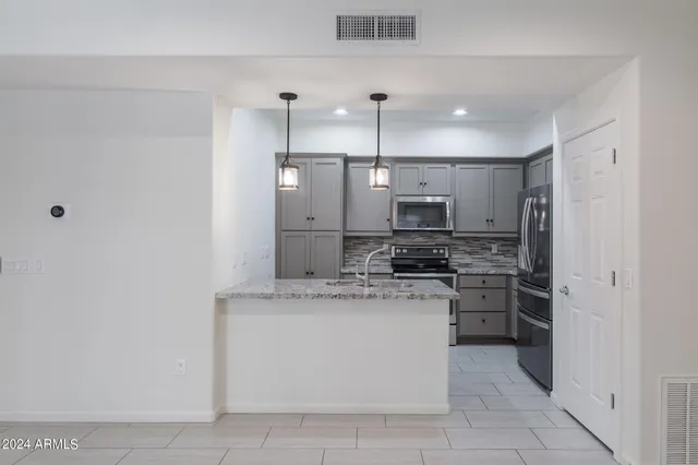 a view of kitchen with furniture and a ceiling fan
