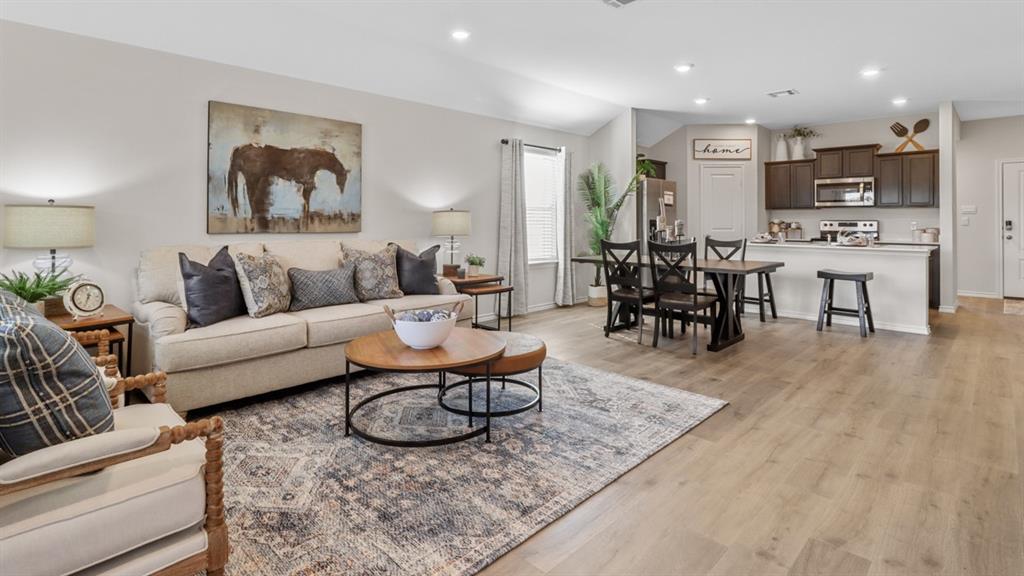 1667 Mantle Road Crandall, TX 75114 - Photo 9 of 20 Spacious open-concept living area featuring light wood-finish flooring, recessed lighting, and a neutral color palette