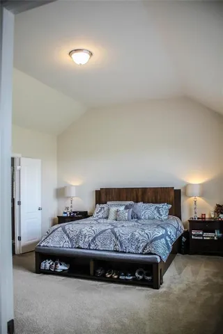 a bedroom with a bed and a night stand