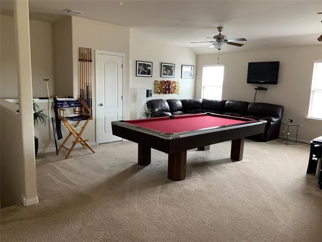 a room with furniture and pool table