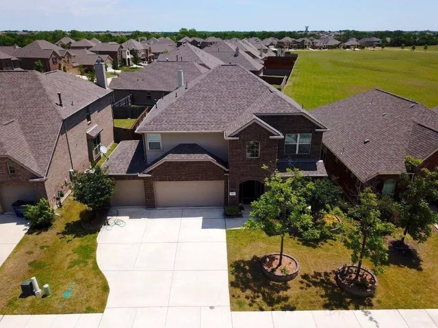 an aerial view of a house with a ocean view