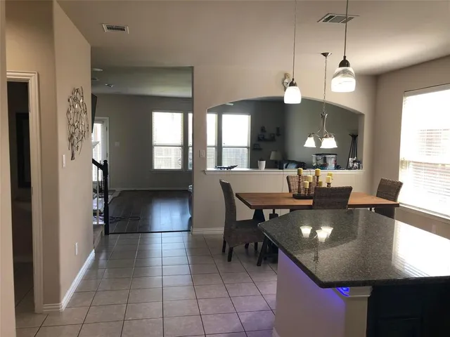 a view of a dining room with furniture and a chandelier
