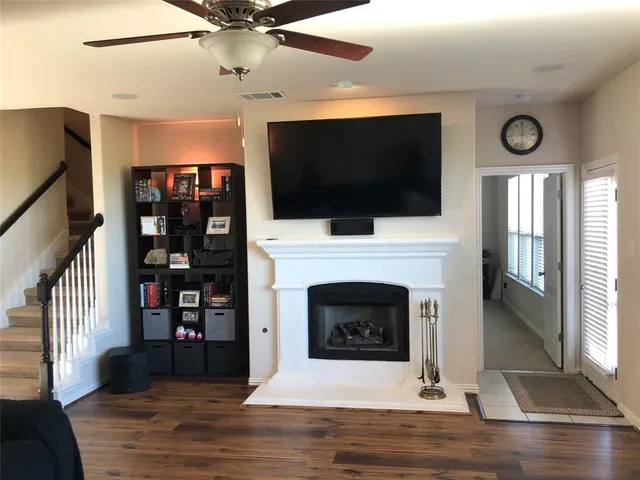 a living room with fireplace furniture a flat screen tv and a fireplace