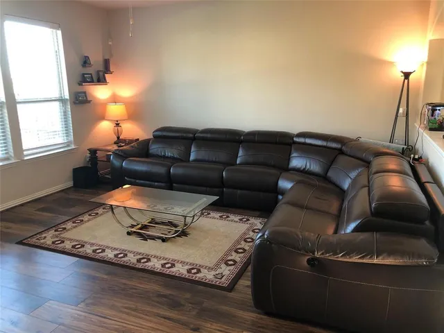 a living room with furniture and a lamp