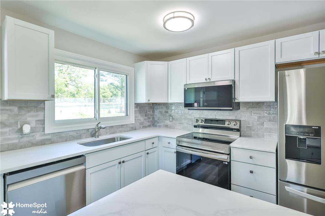415 Willow Road Hellertown, PA 18055 - Photo 13 of 25 Gleaming stainless steel appliances complement the bright white cabinetry and sleek countertops in this modern kitchen.
