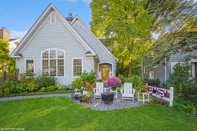 a front view of a house with a yard and sitting area