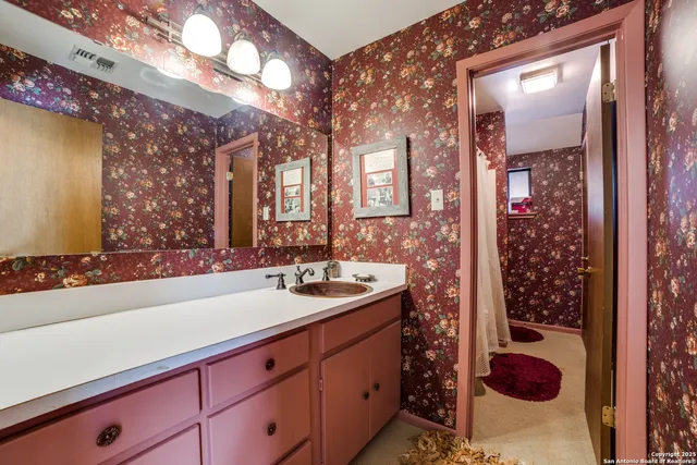 a living room with lots of furniture and clutter