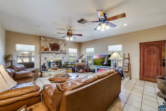 a kitchen with stainless steel appliances granite countertop a stove top oven a sink dishwasher and a refrigerator with the cabinets