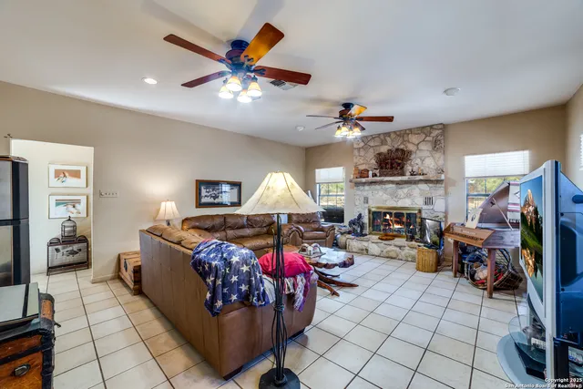 a kitchen with stainless steel appliances granite countertop a stove top oven a sink dishwasher a refrigerator and cabinets with wooden floor