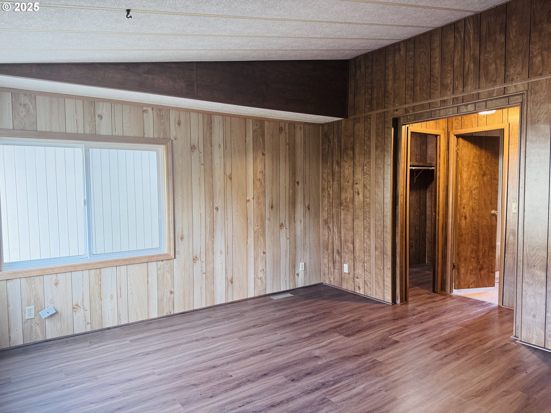 380 Leelo Court Florence, OR 97439 - Photo 18 of 37 an empty room with wooden floor and windows