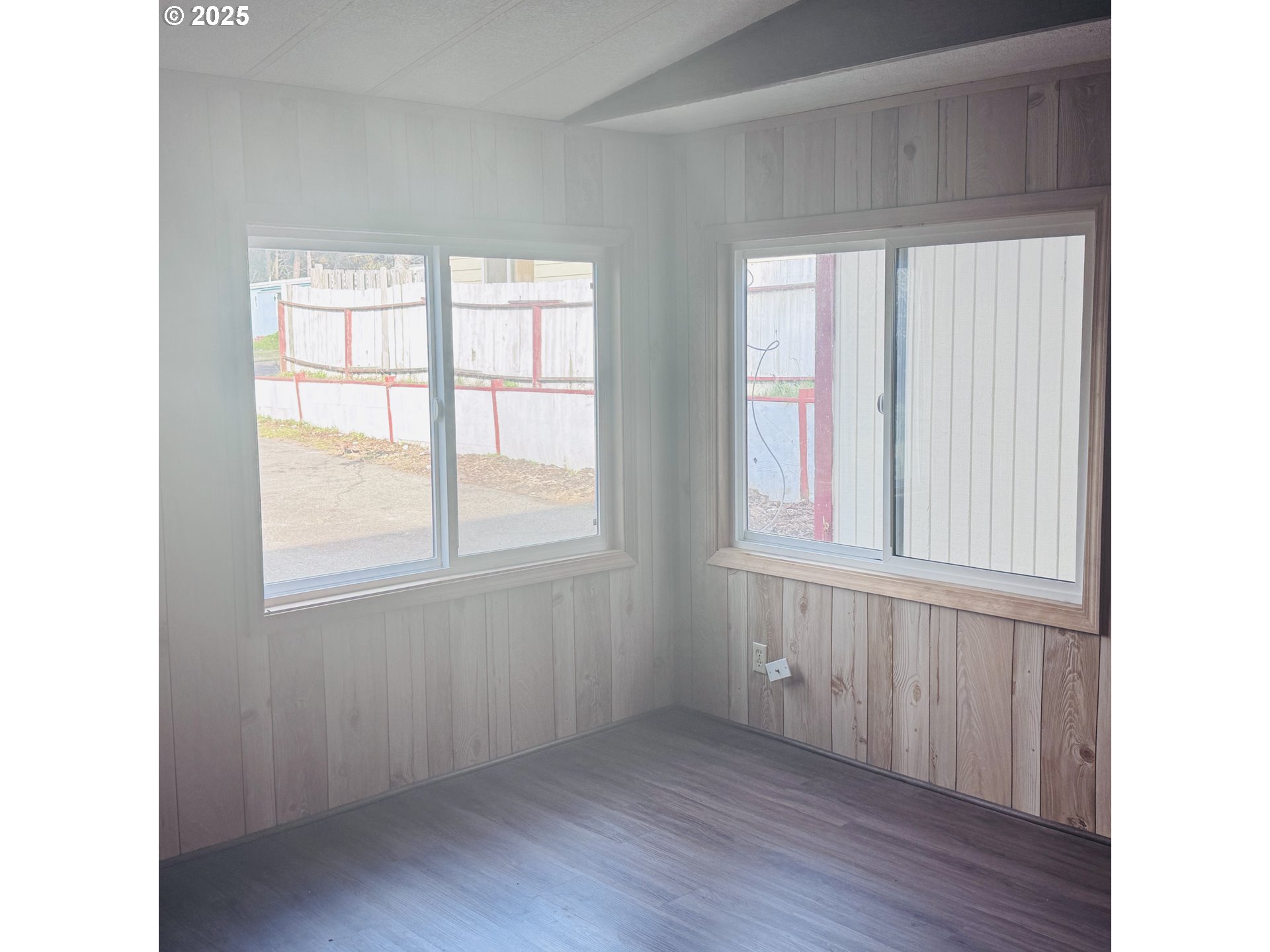 380 Leelo Court Florence, OR 97439 - Photo 19 of 37 a view of an empty room with wooden floor and a window