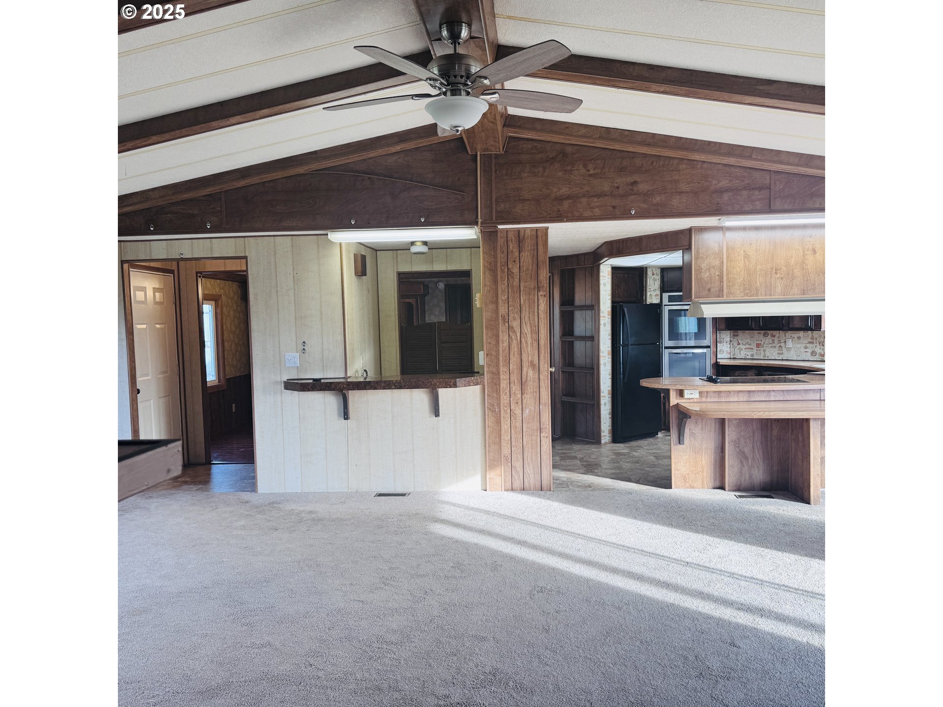 380 Leelo Court Florence, OR 97439 - Photo 6 of 37 a view of a kitchen with a sink and a refrigerator