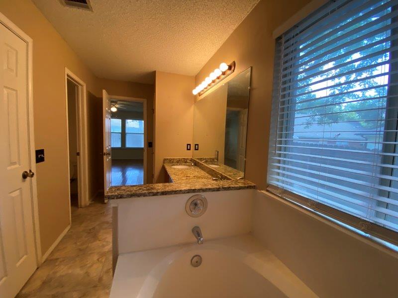 1903 Balsam Way Round Rock, TX 78665 - Photo 10 of 21 Double vanity with granite counters and a deep soaking tub complete this well-appointed Primary bath.
