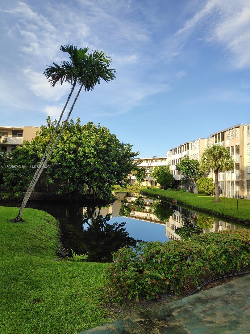 1680 Northeast 191st Street, Unit 2182 Miami, FL 33179 - Photo 7 of 8 a view of a lake with a big yard