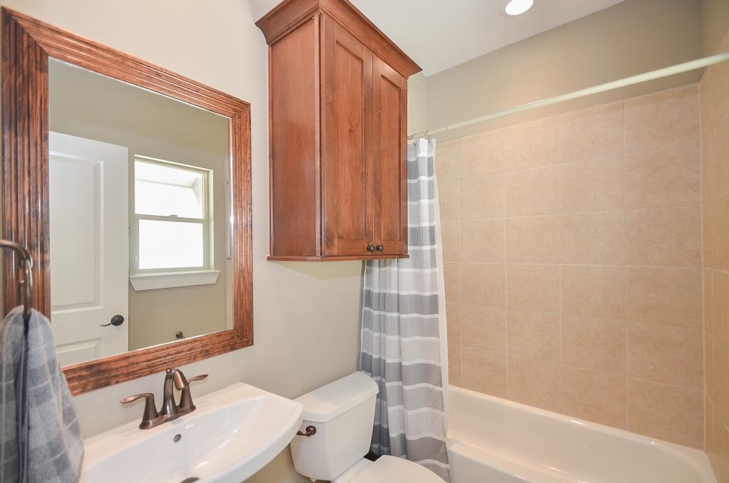 2214 Radcliffe Street Houston, TX 77007 - Photo 12 of 15 a bathroom with a sink toilet and shower