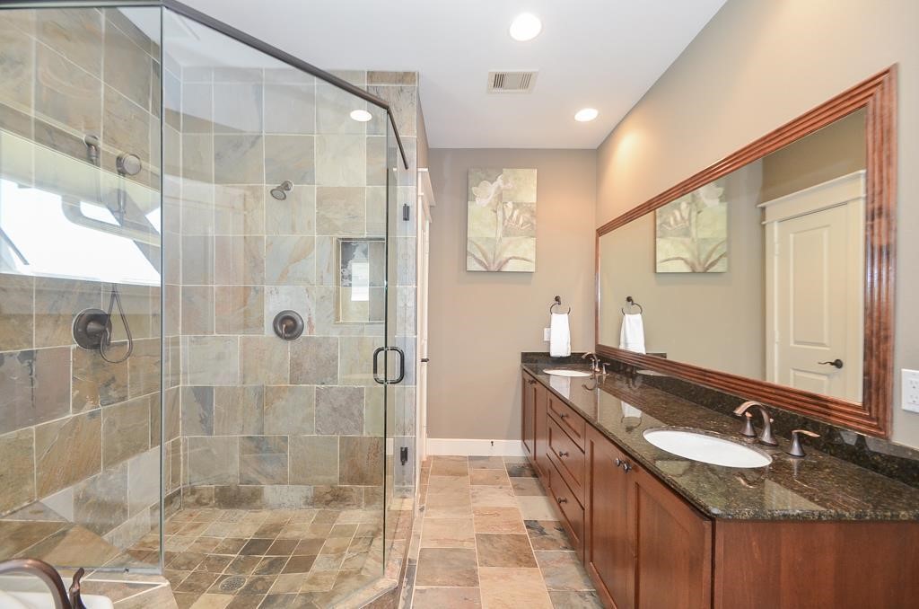 2214 Radcliffe Street Houston, TX 77007 - Photo 9 of 15 a bathroom with a granite countertop sink mirror and shower