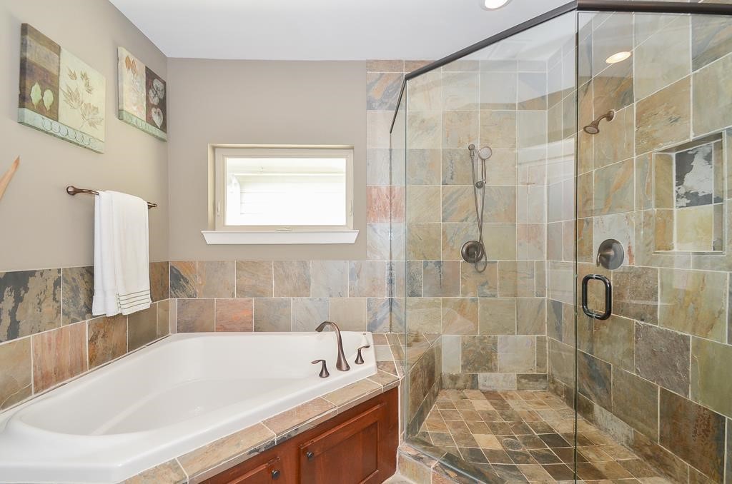 2214 Radcliffe Street Houston, TX 77007 - Photo 10 of 15 a bath tub sitting next to a white sink and a shower