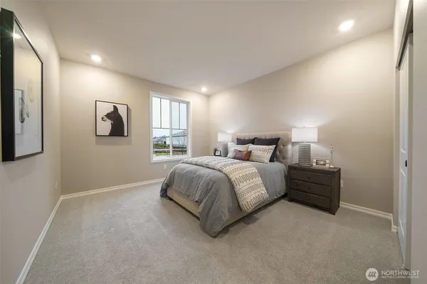 a spacious bedroom with a bed and a window