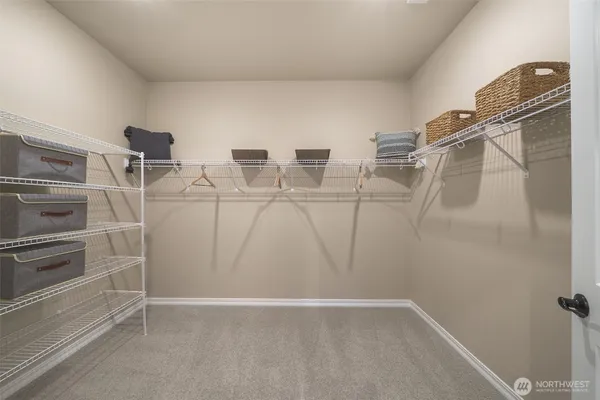 a living room with hardwood floor and large windows
