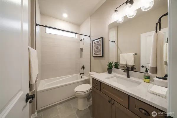 a bathroom with a double vanity sink toilet mirror and shower