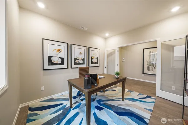 a living room with couch and a view of kitchen appliances