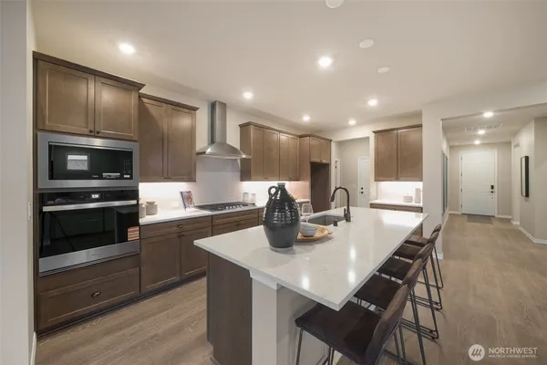 a kitchen with cabinets and stainless steel appliances