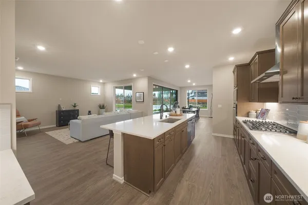 a large white kitchen with a large counter top appliances and cabinets