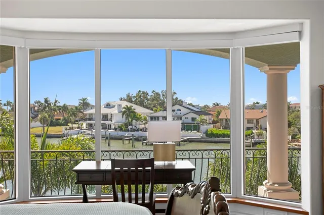 a bedroom with a large bed and a large window