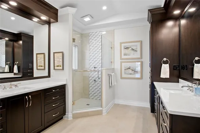 a bathroom with a double vanity sink mirror and shower