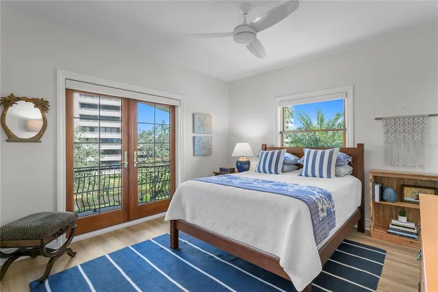 a bathroom with a granite countertop toilet a sink a mirror a bathtub and shower