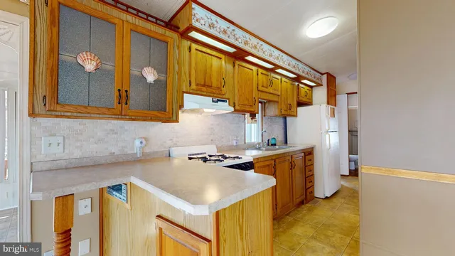 a kitchen with a sink and a stove top oven