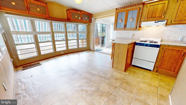 a view of a kitchen with fridge and a sink