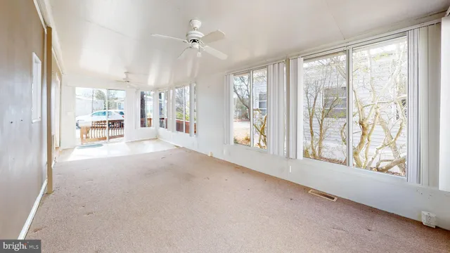 a view of a livingroom with wooden floor and a large window