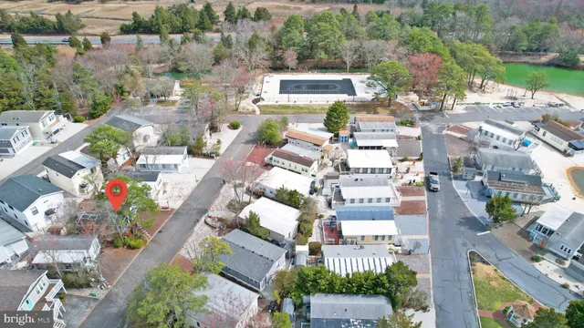 an aerial view of a house with a swimming pool and outdoor seating
