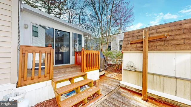 a backyard of a house with wooden floor and outdoor seating