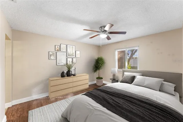 a bedroom with a large bed and a chandelier