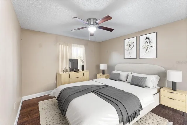 a bedroom with a large bed and a chandelier