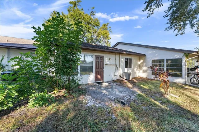 a view of a house with backyard porch and sitting area