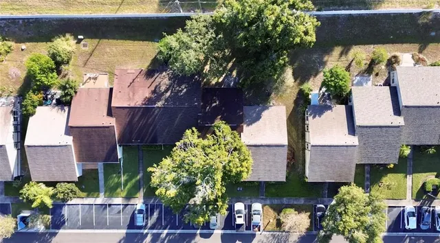 a front view of a house with a yard and potted plants