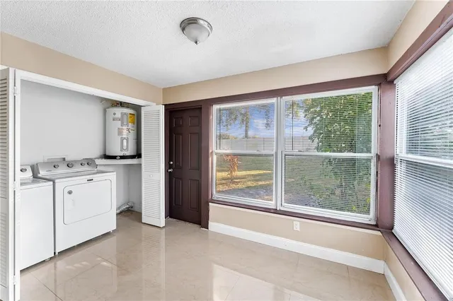 a view of a kitchen with a sink dishwasher and a large window