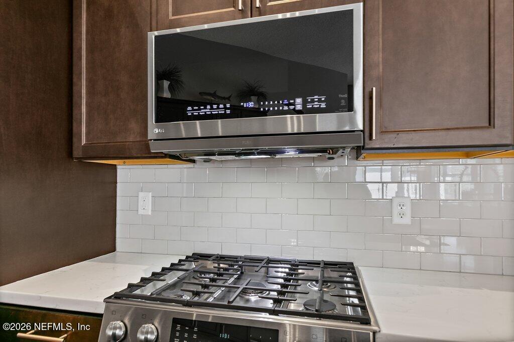 841 Ifield Road St. Augustine, FL 32095 - Photo 15 of 69 a kitchen with a stove and a microwave