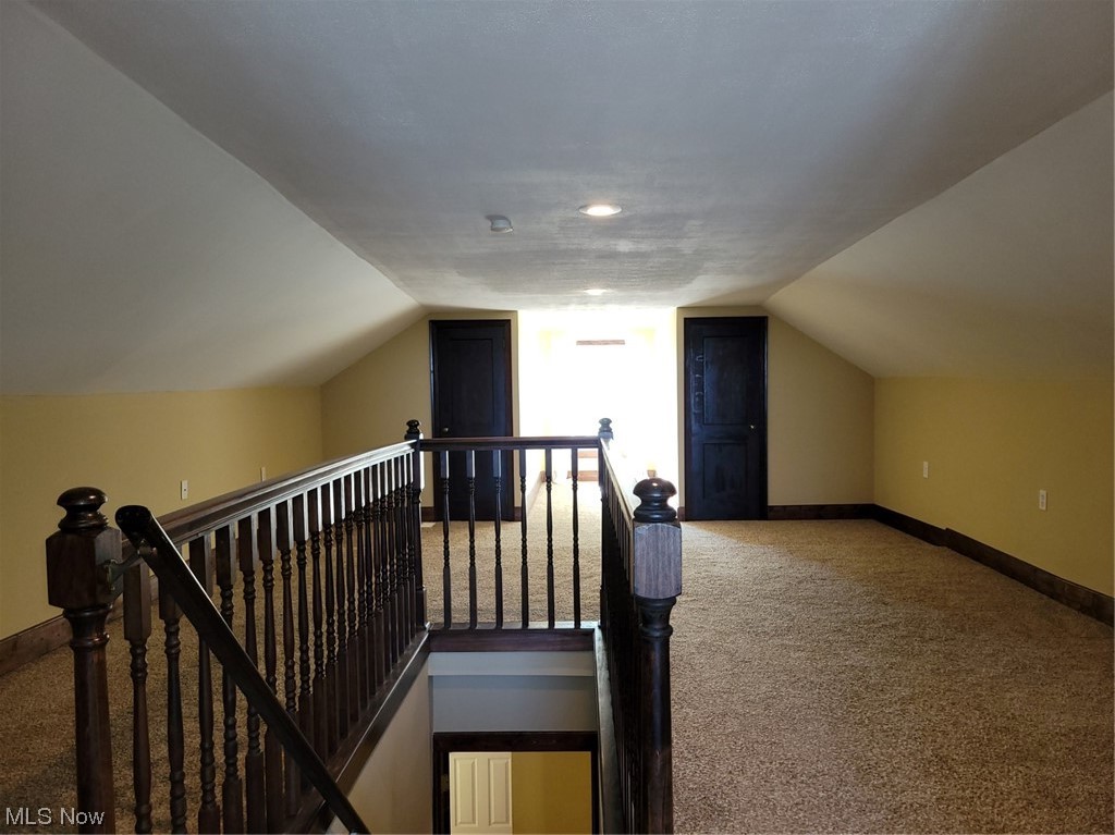 22922 Putney Ridge Road Quaker City, OH 43773 - Photo 27 of 31 Stairway with light carpet and vaulted ceiling