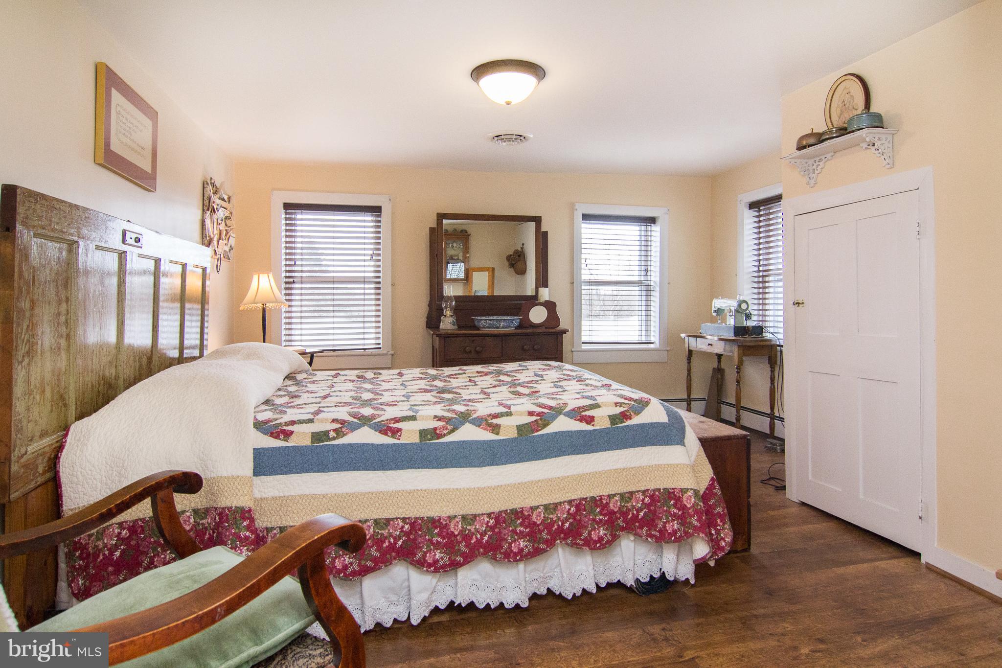 3358 Uniontown Road Westminster, MD 21158 - Photo 17 of 30 a bedroom with a bed and wooden floor